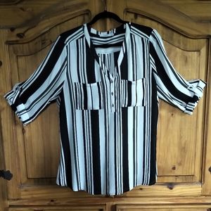 **Ricki's** V-Neck popover blouse with roll up sleeve ties.